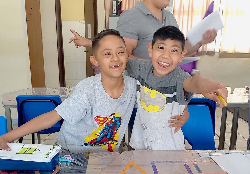 Two students posing for a photo in the classroom